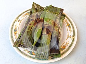 Pulut panggang is a Malay or Nonya cuisine literally translated as Ã¢â¬Ågrilled glutinous riceÃ¢â¬Â. photo